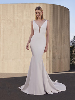 Woman wearing a white wedding dress with a plain background pronovias snowbeet
