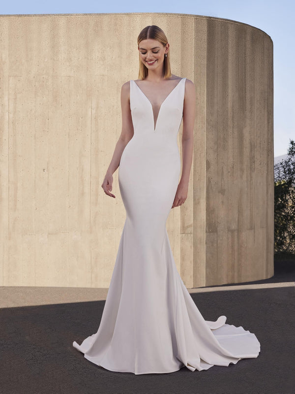 Woman wearing a white wedding dress with a plain background pronovias snowbeet
