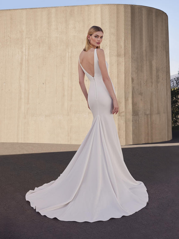 Woman wearing a white wedding dress with a plain background pronovias snowbeet open back