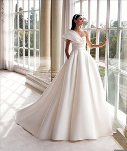 Pronovias Sedna  dress with princess cut asymmetrical neckline and cap sleeves