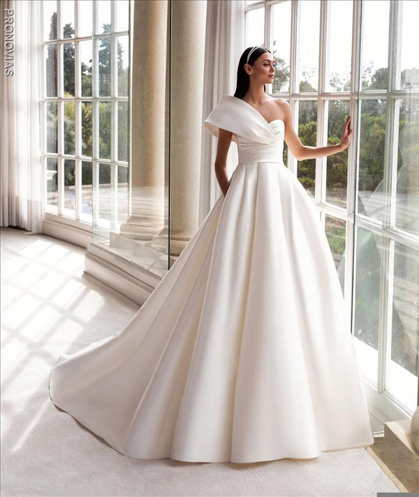 Pronovias Sedna  dress with princess cut asymmetrical neckline and cap sleeves